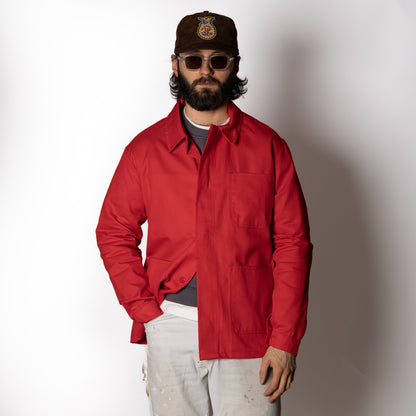 Men's red long-sleeve chore jacket with button front and three patch pockets