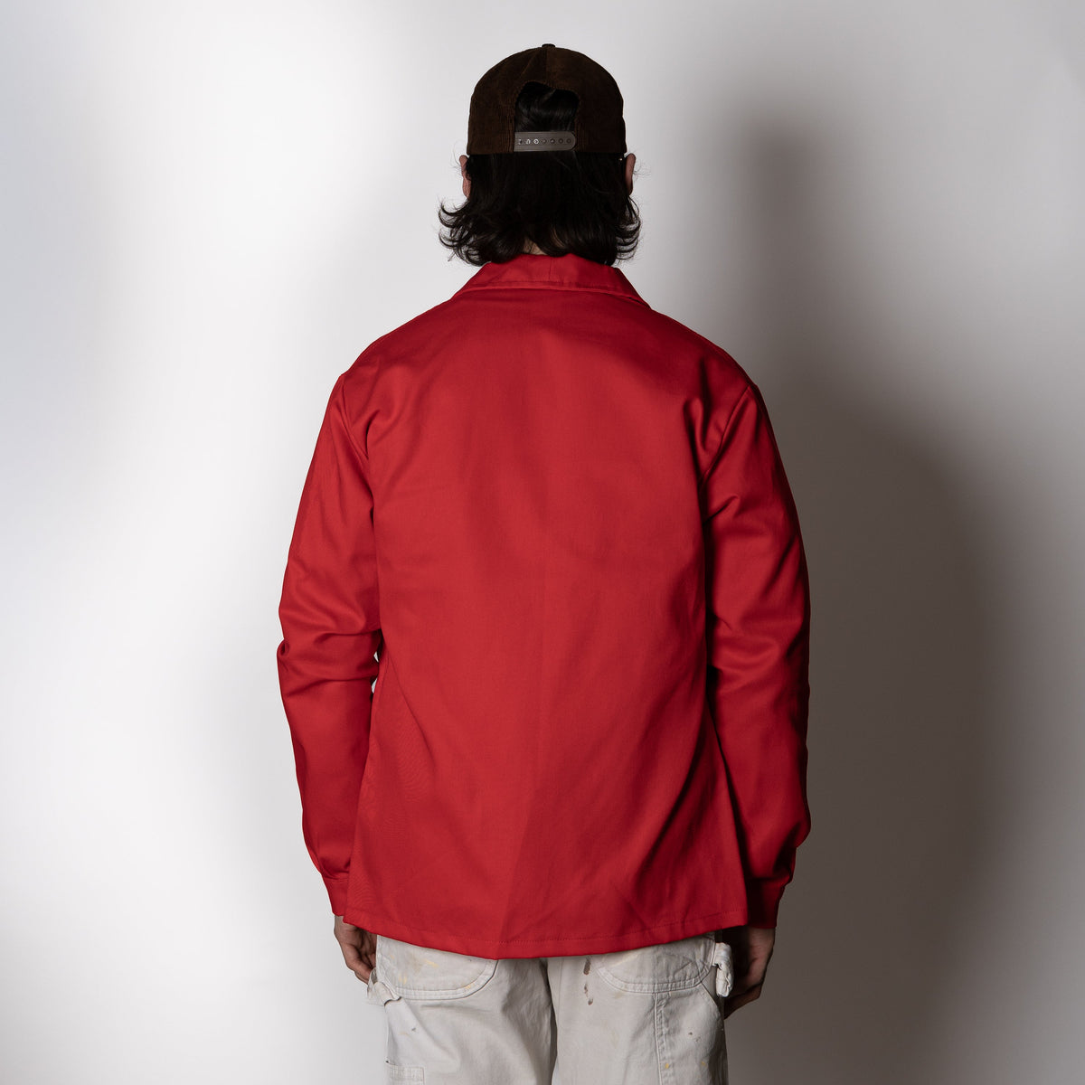 Men's red long-sleeve chore jacket with button front and three patch pockets