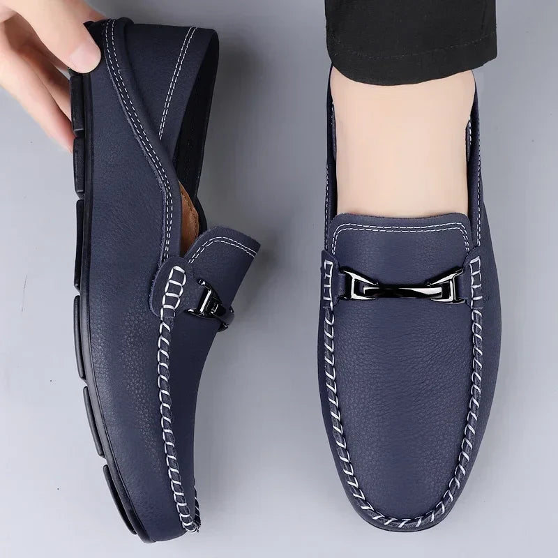 Slip-on loafers with moc toe stitching and a polished metal bar detail