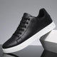 Men's low-top lace-up sneakers with round toe and flat white sole