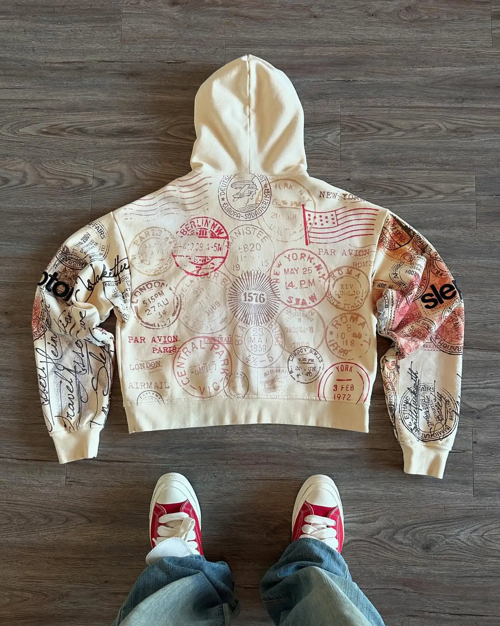 Beige zip-up hoodie with hood and all-over postal stamp graphic print