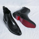 Men's Chelsea boots with square toes, elastic side panels and pull tabs shown in black and red