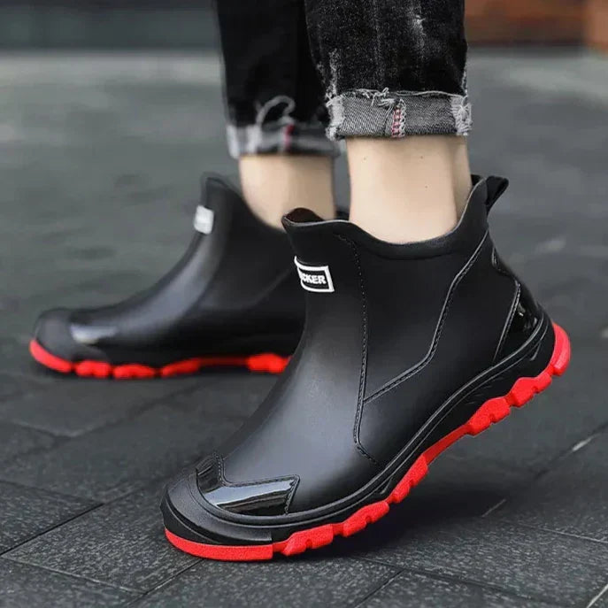 Black Chelsea ankle boots with elastic panels and lugged soles