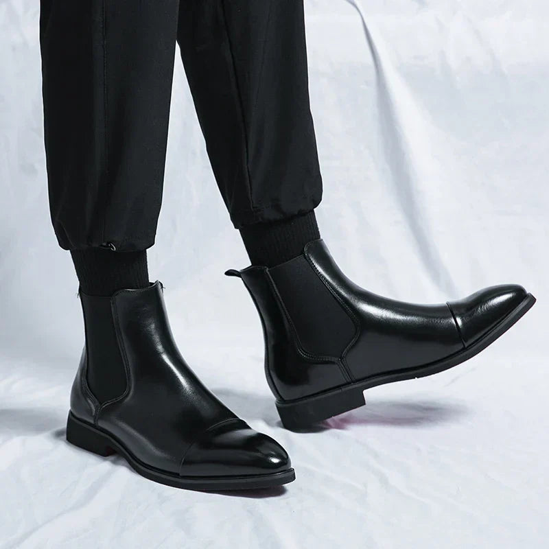 Men's Chelsea boots with square toes, elastic side panels and pull tabs shown in black and red