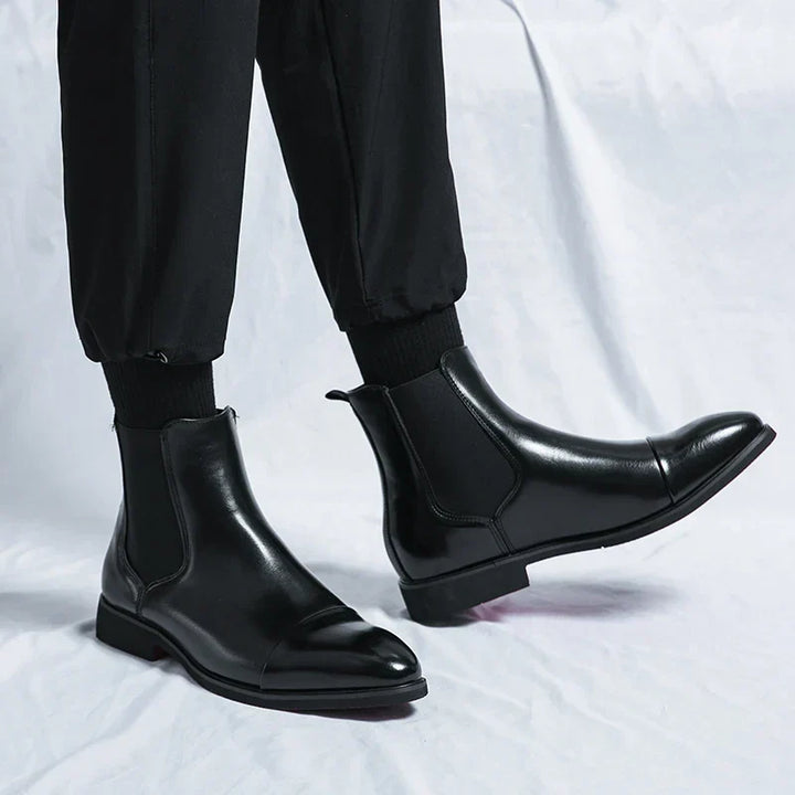 Men's Chelsea boots with square toes, elastic side panels and pull tabs shown in black and red