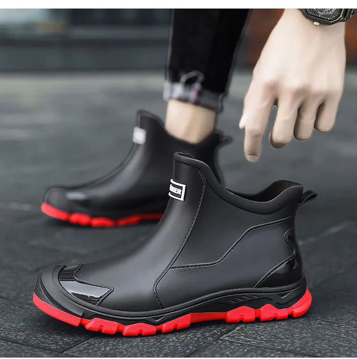 Black Chelsea ankle boots with elastic panels and lugged soles