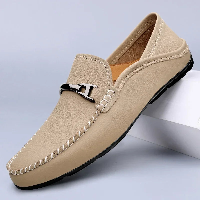 Slip-on loafers with moc toe stitching and a polished metal bar detail