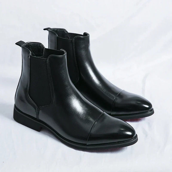Men's Chelsea boots with square toes, elastic side panels and pull tabs shown in black and red