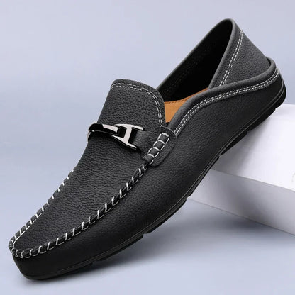 Slip-on loafers with moc toe stitching and a polished metal bar detail