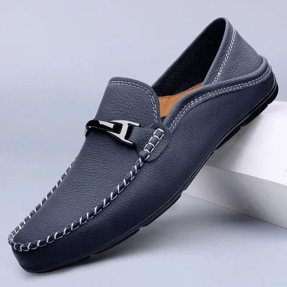 Slip-on loafers with moc toe stitching and a polished metal bar detail