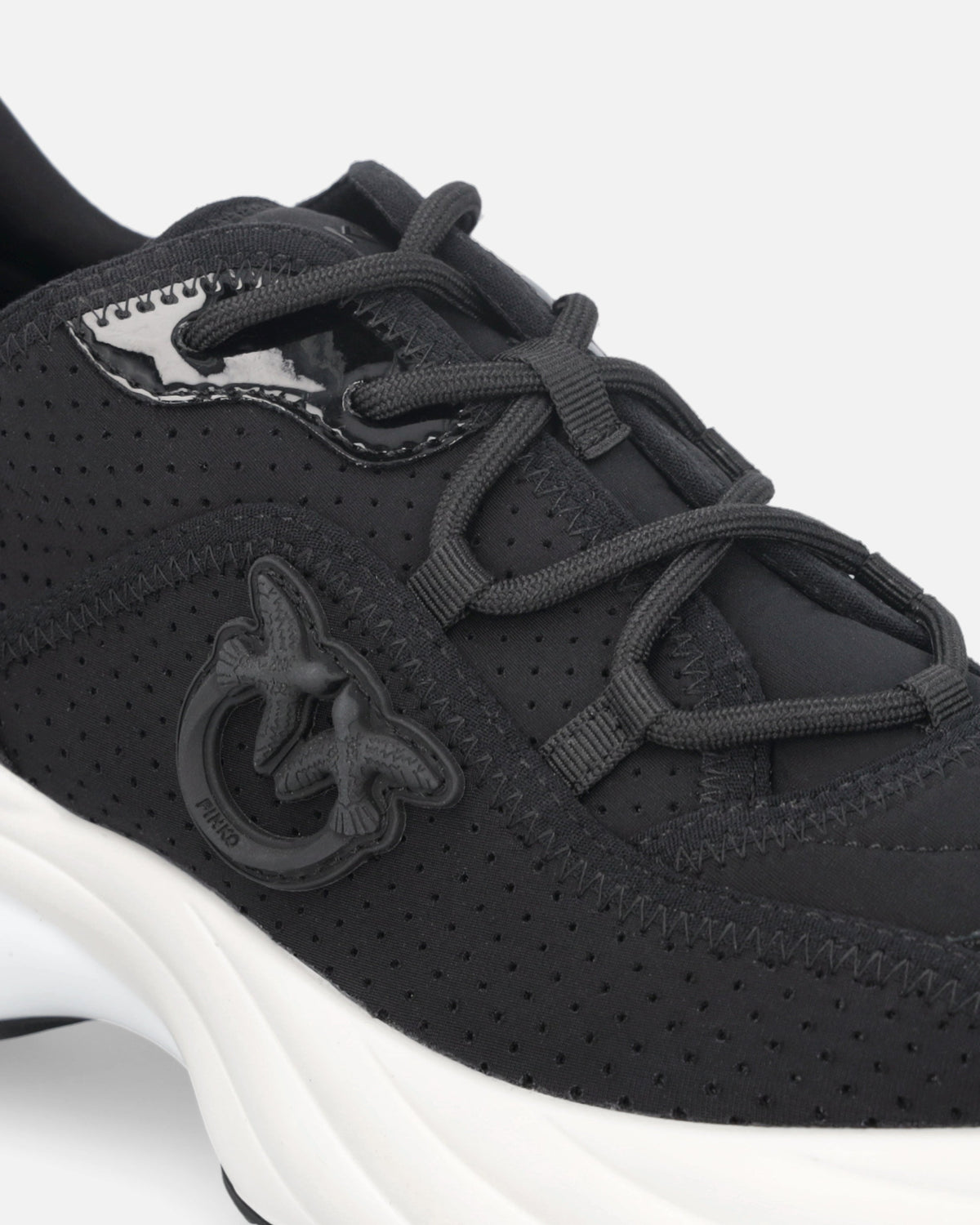 Black perforated lace-up sneakers with logo detail and chunky white sole
