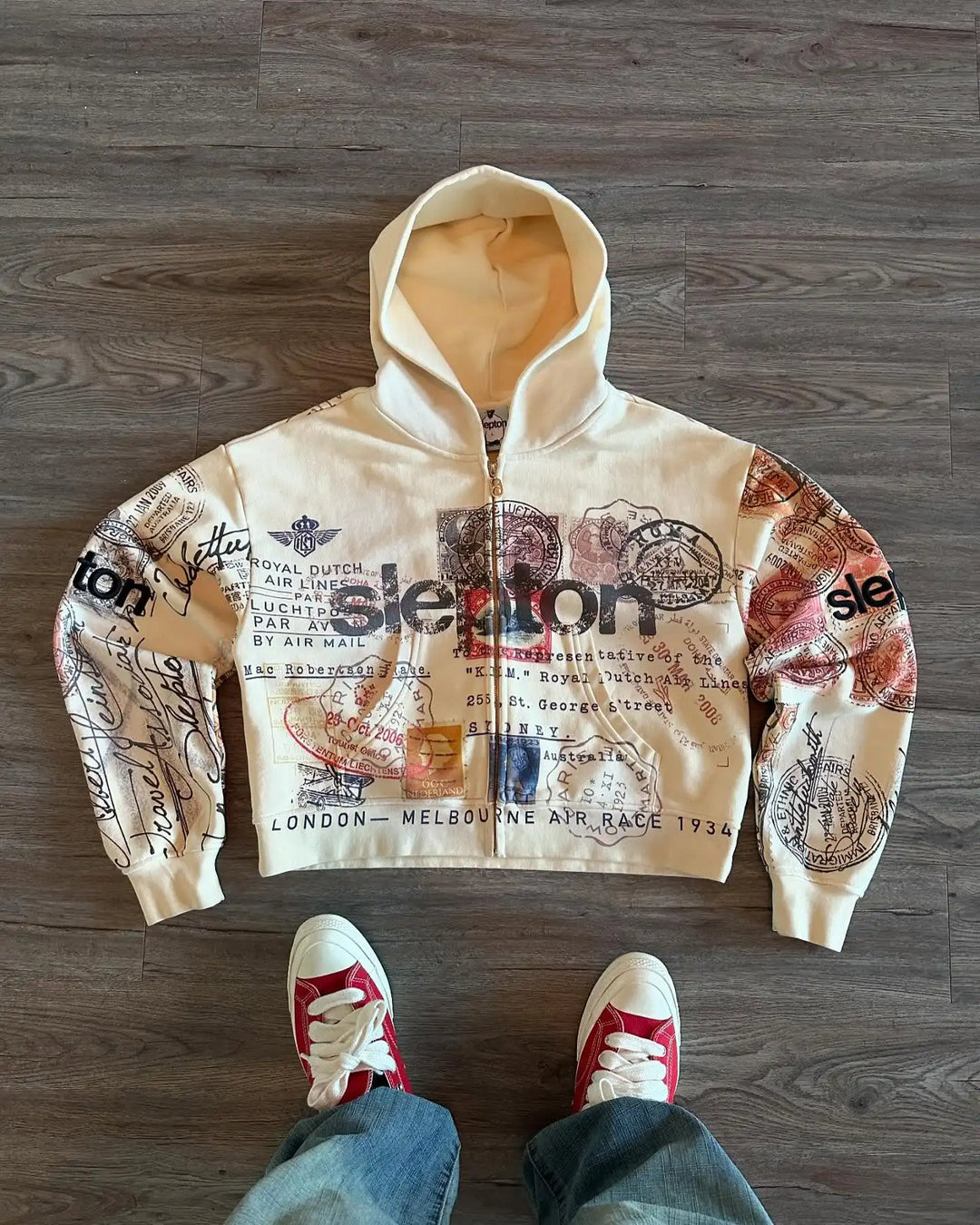 Beige zip-up hoodie with hood and all-over postal stamp graphic print