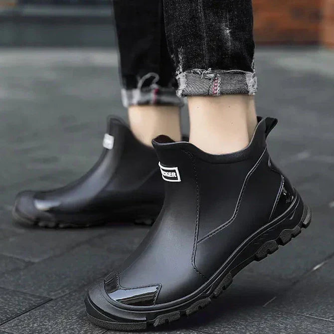 Black Chelsea ankle boots with elastic panels and lugged soles