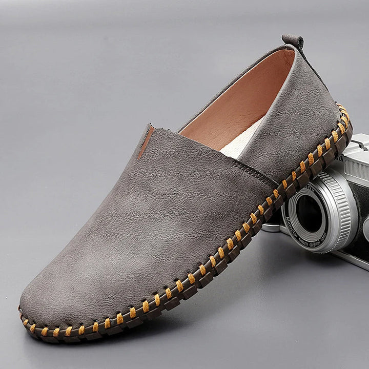Men's dark brown leather loafers with contrasting stitched moc-toe and trim
