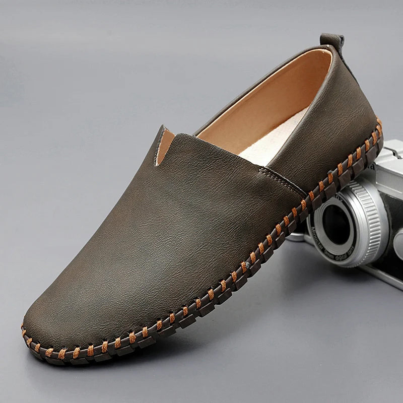 Men's dark brown leather loafers with contrasting stitched moc-toe and trim