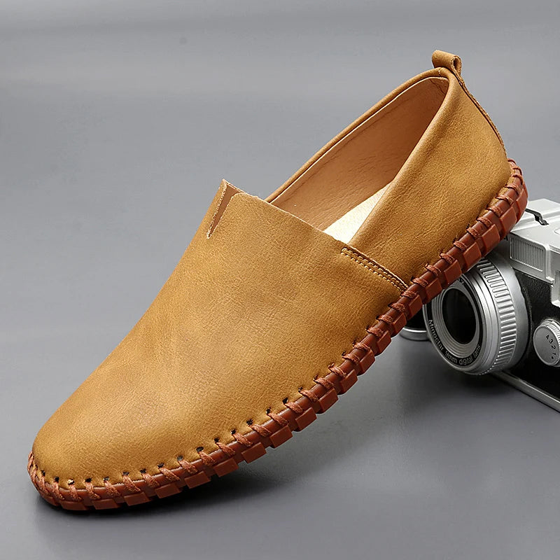 Men's dark brown leather loafers with contrasting stitched moc-toe and trim