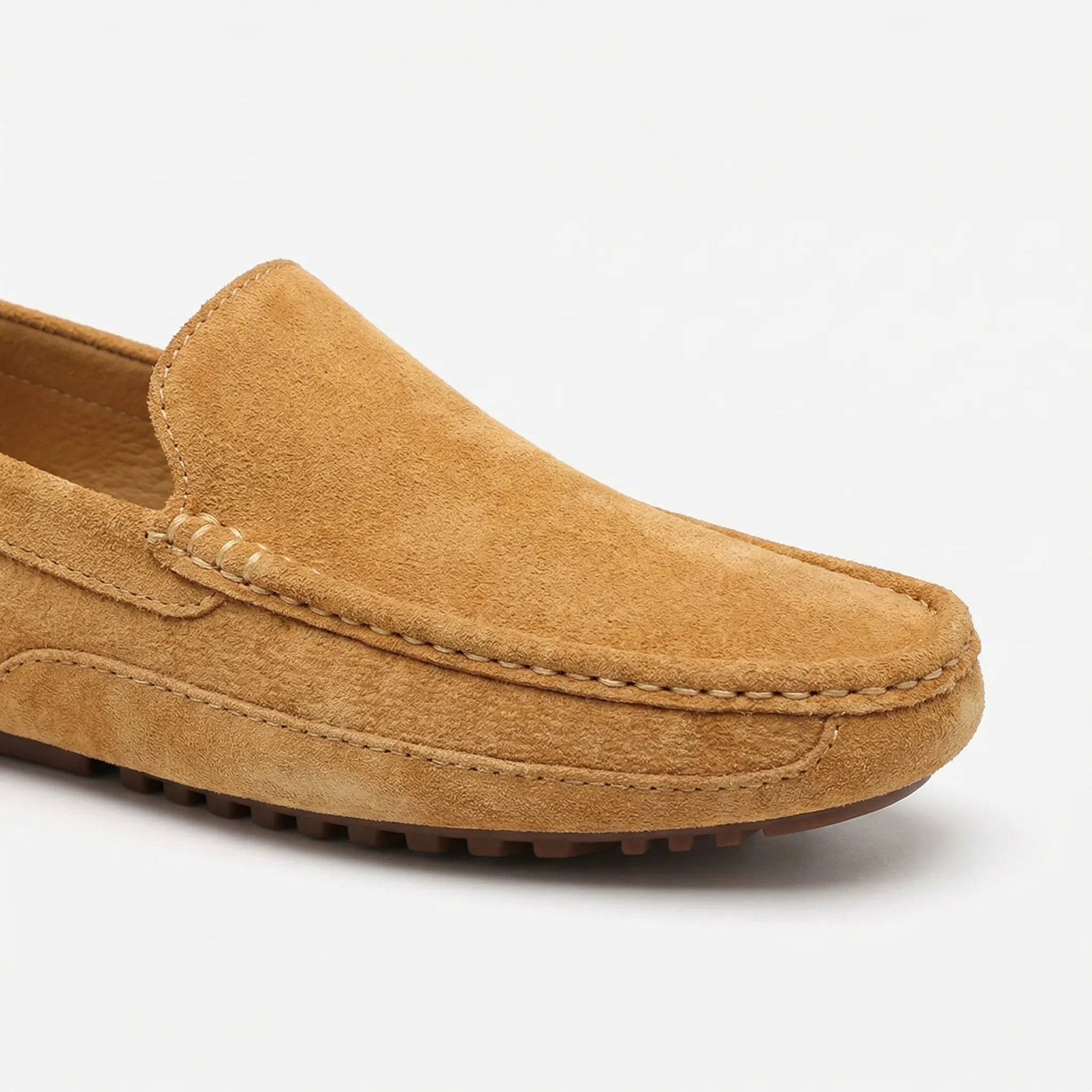 Men's slip-on moccasin loafers with stitched trim and ridged soles