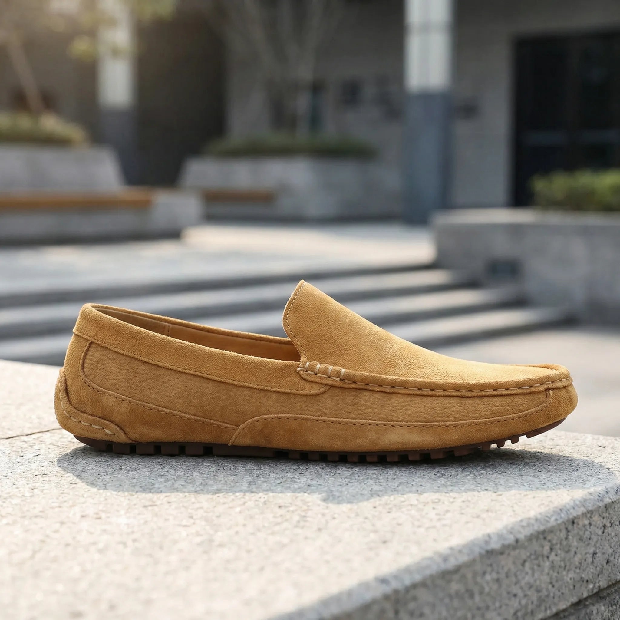 Men's slip-on moccasin loafers with stitched trim and ridged soles