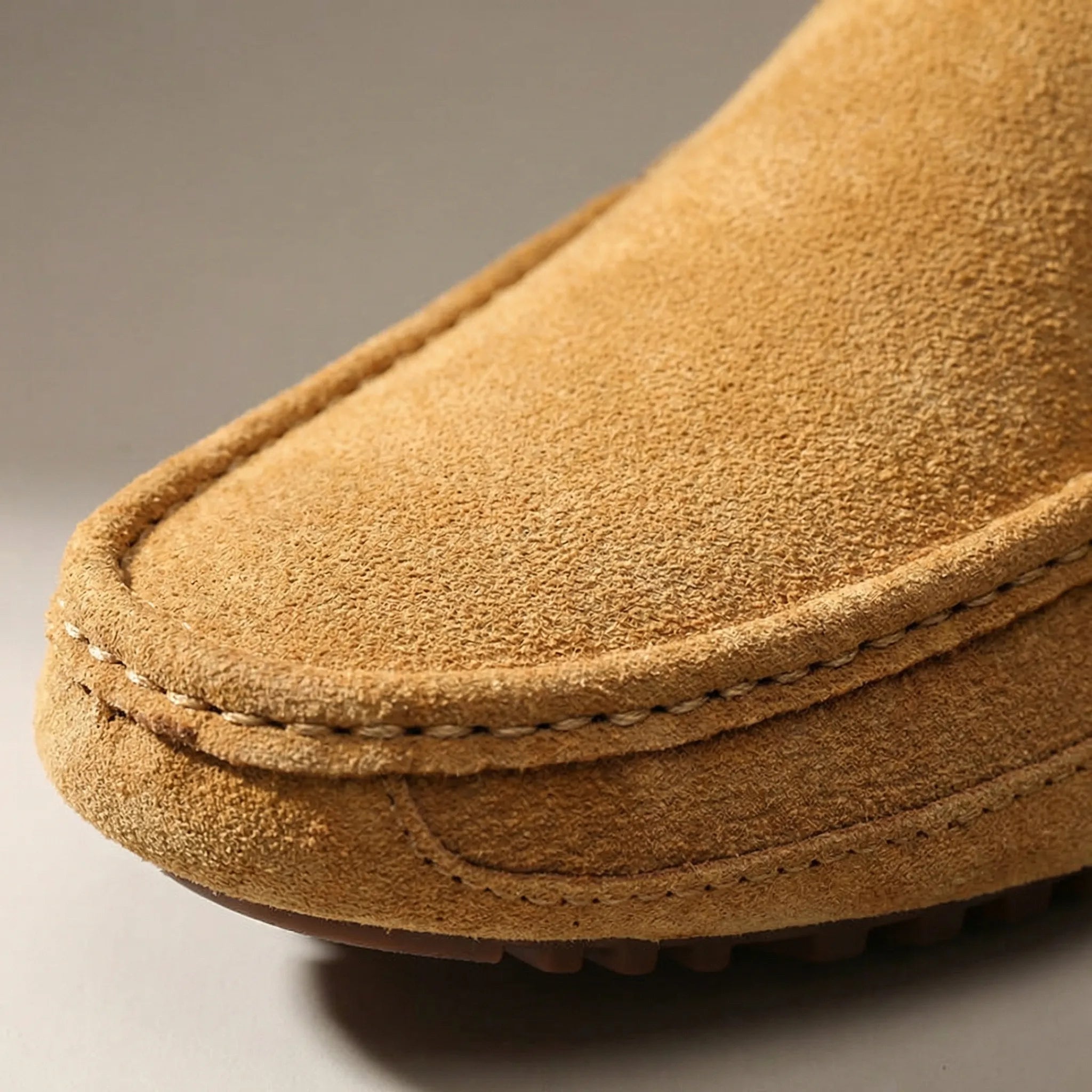 Men's slip-on moccasin loafers with stitched trim and ridged soles