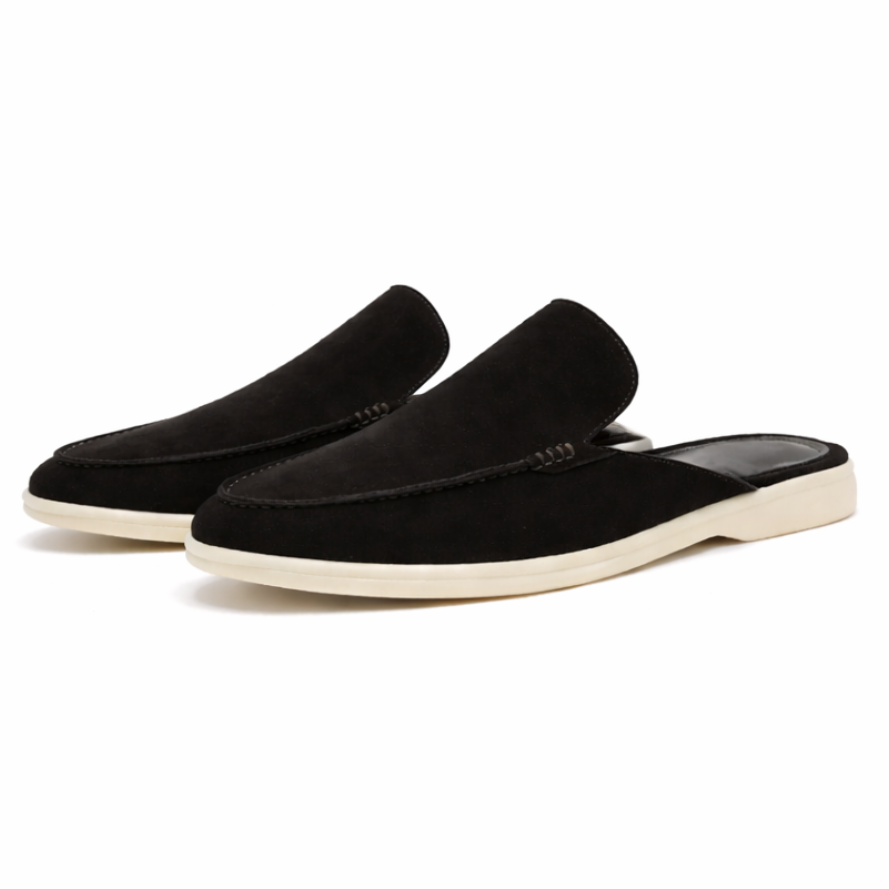 Black loafer mule with cream-coloured sole, shown from the side profile