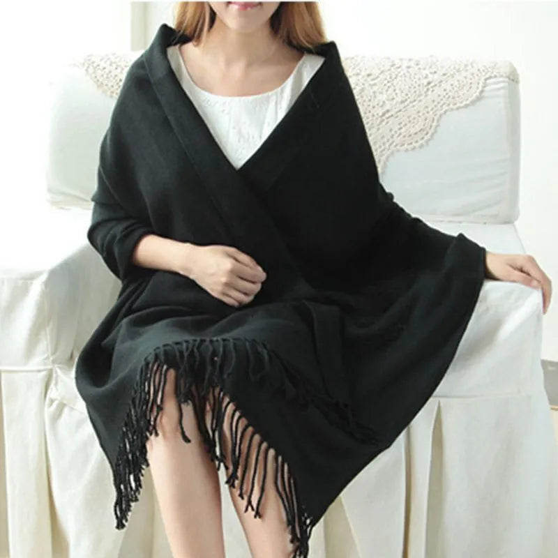 Oversized fringed wrap scarf shown draped around the shoulders and neck