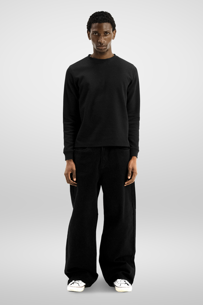 Men's black long-sleeve crew-neck top with textured finish and ribbed cuffs