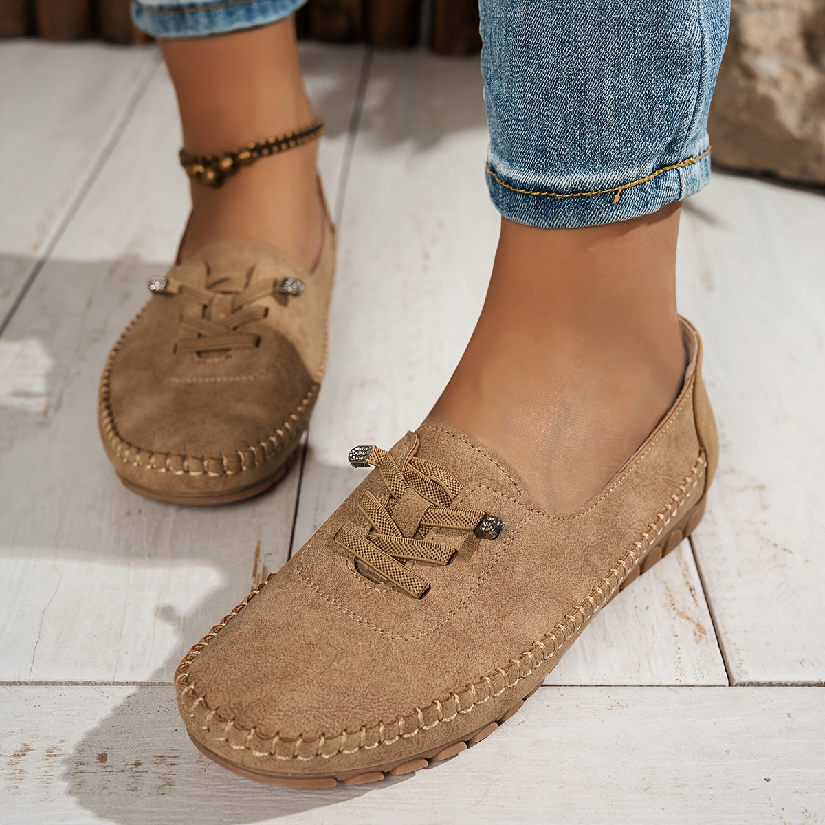 Women's grey and beige lace-up moccasin loafers with cushioned sole, worn with jeans