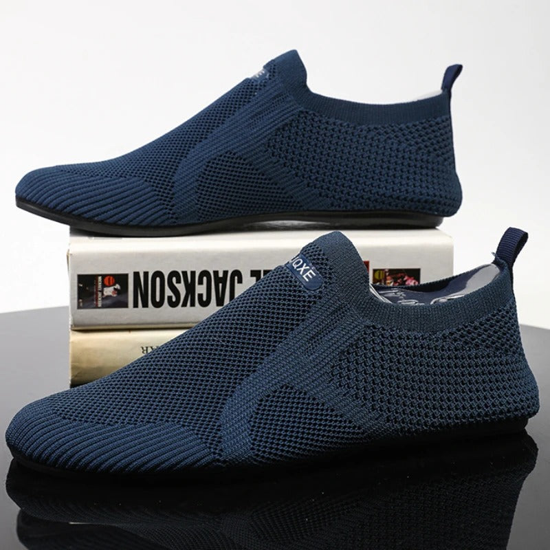 Knit slip-on shoes with round toes, pull tabs and flat soles