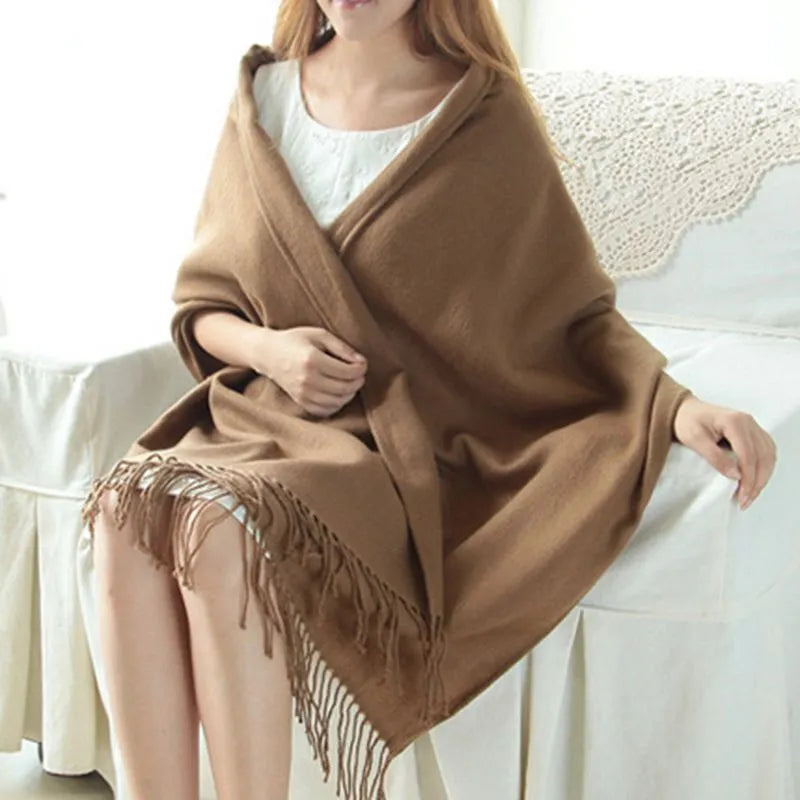 Oversized fringed wrap scarf shown draped around the shoulders and neck