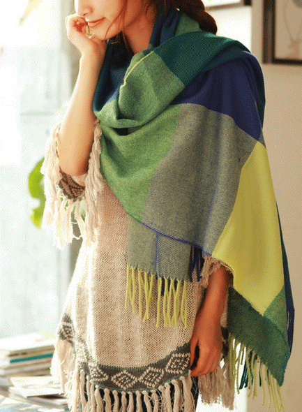 Oversized fringed wrap scarf shown draped around the shoulders and neck