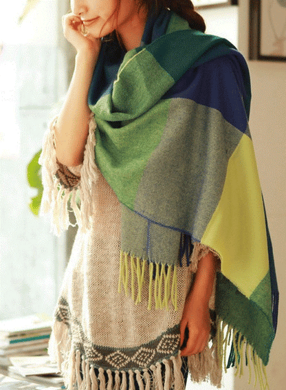 Oversized fringed wrap scarf shown draped around the shoulders and neck