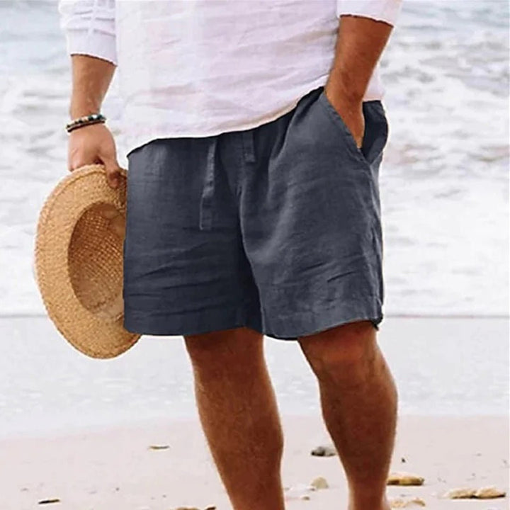 Men's relaxed fit shorts with drawstring waist, shown in tan and navy