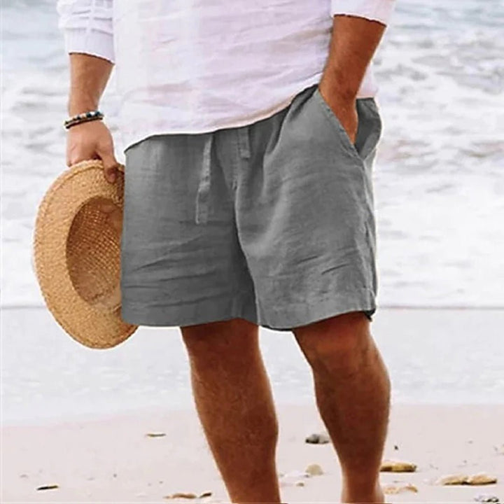 Men's relaxed fit shorts with drawstring waist, shown in tan and navy