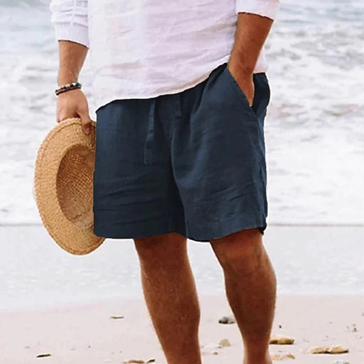 Men's relaxed fit shorts with drawstring waist, shown in tan and navy