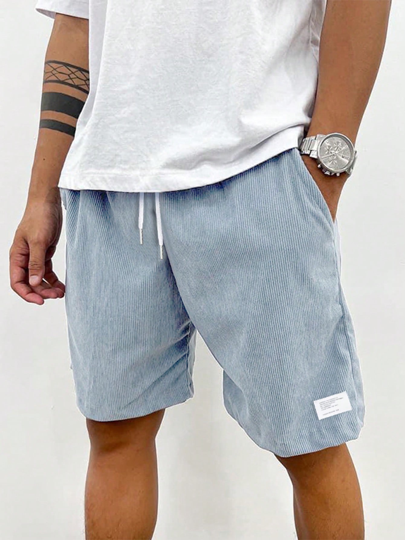 Men's relaxed fit shorts with elastic waist and drawstring, shown in green and beige
