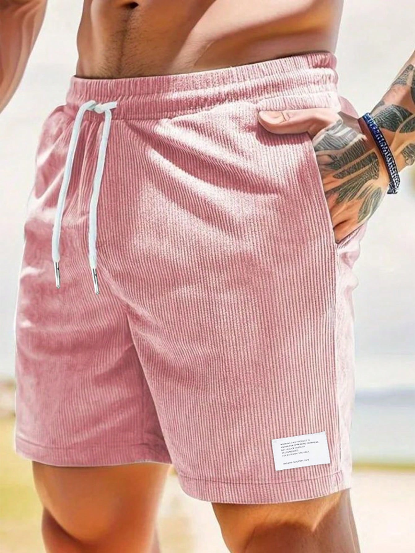 Men's relaxed fit shorts with elastic waist and drawstring, shown in green and beige