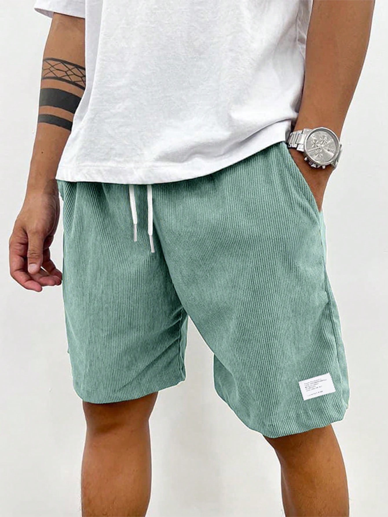 Men's relaxed fit shorts with elastic waist and drawstring, shown in green and beige