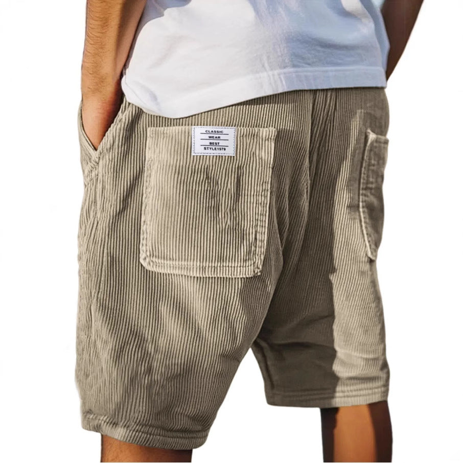 Men's grey ribbed shorts with stitched back pockets, shown from the rear on a model wearing a white t-shirt