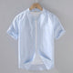 Men's beige short sleeve stand collar shirt with button front, flat lay view