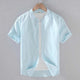 Men's beige short sleeve stand collar shirt with button front, flat lay view