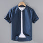 Men's beige short sleeve stand collar shirt with button front, flat lay view