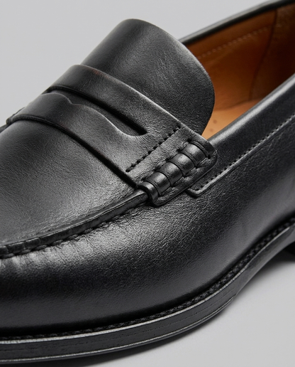 Men's slip-on loafers with moc toe stitching and penny strap detail