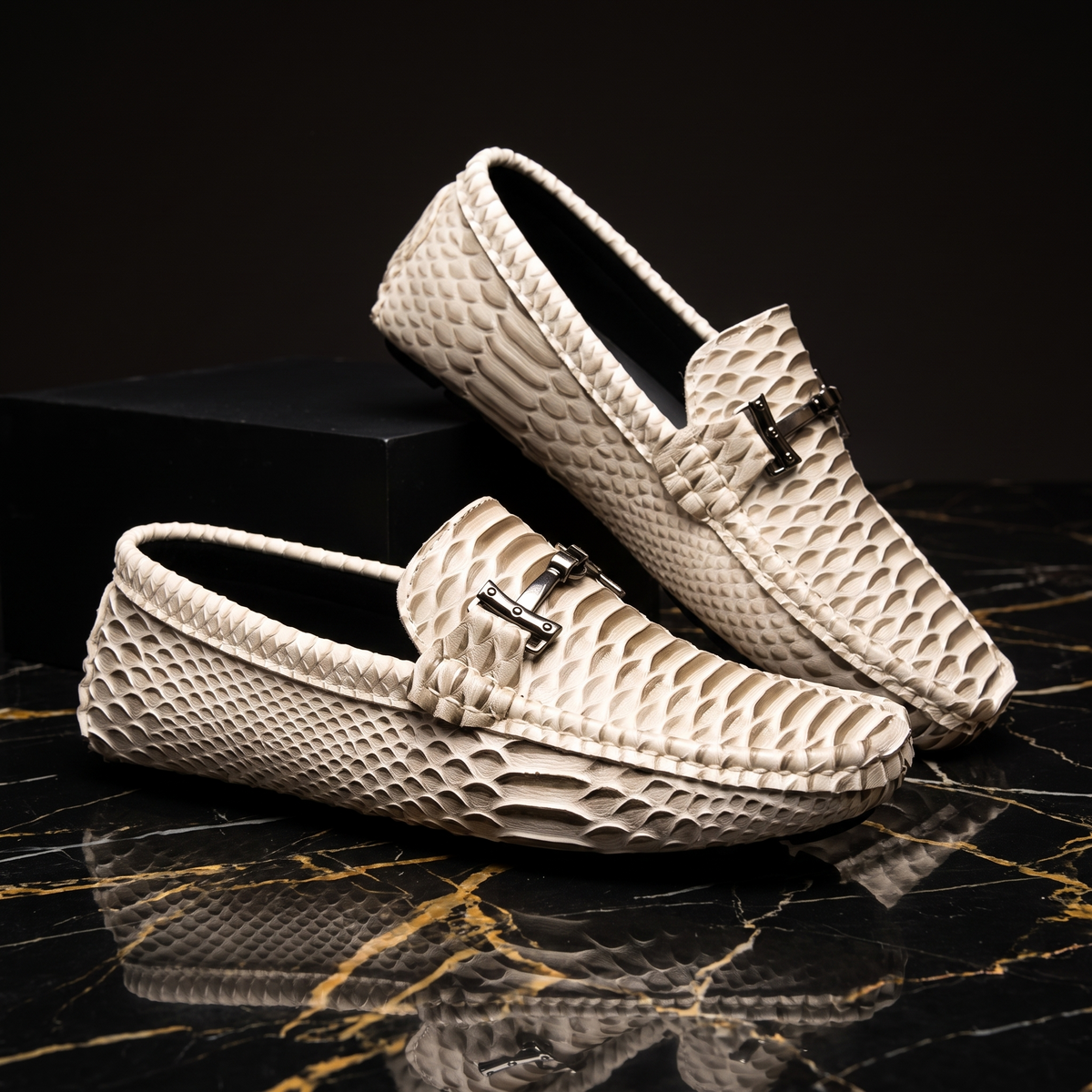 Textured loafers with metal buckle details and rounded toes