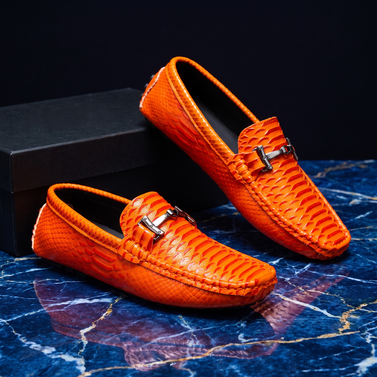 Textured loafers with metal buckle details and rounded toes
