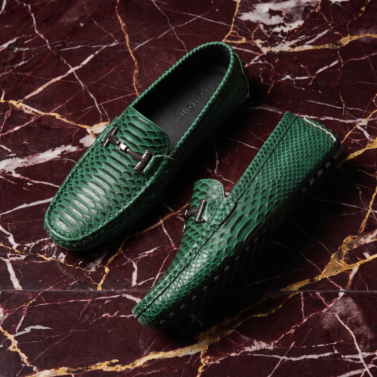 Textured loafers with metal buckle details and rounded toes