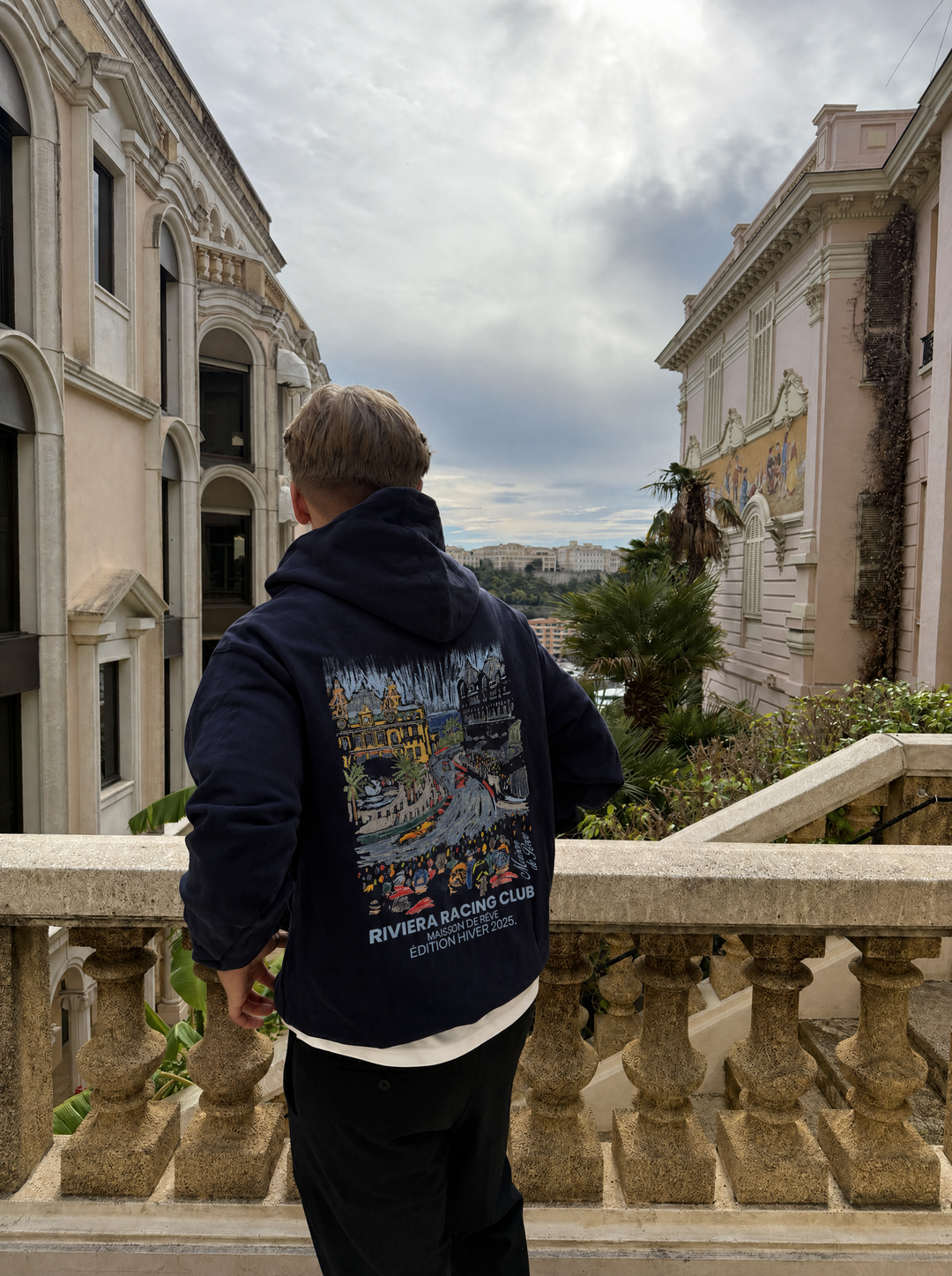 Graphic Riviera Racing Club hoodie with illustrated racing scene on the back
