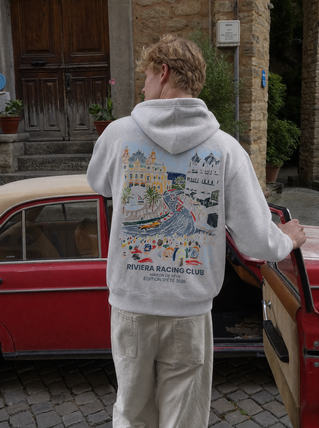Graphic Riviera Racing Club hoodie with illustrated racing scene on the back