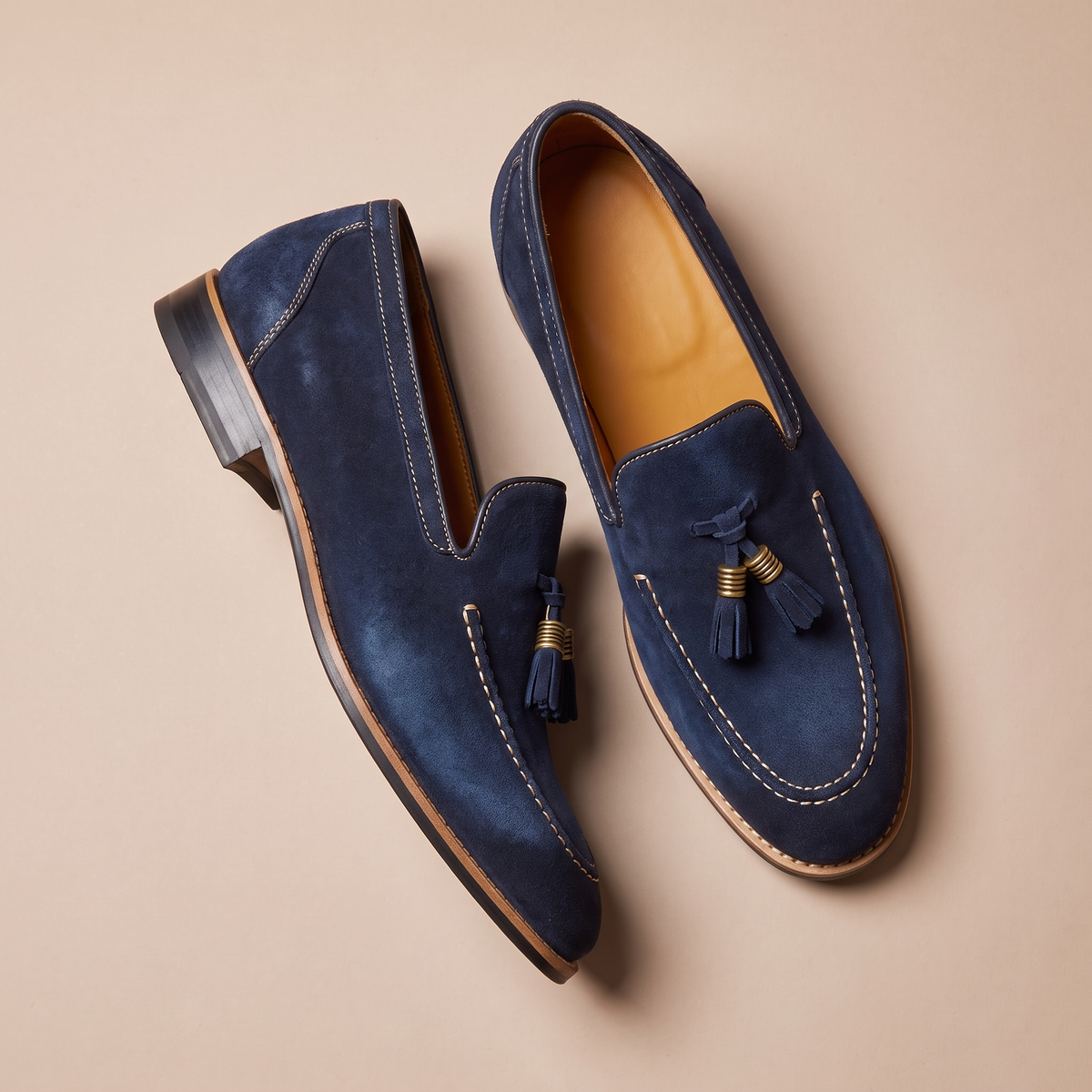 Men's slip-on loafers with tassel detail, moc toe stitching and low block heel