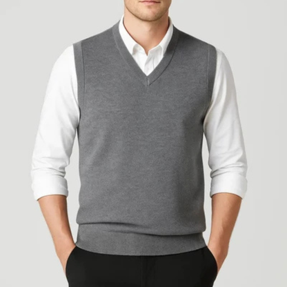 Men's sleeveless V-neck sweater vest layered over a collared shirt