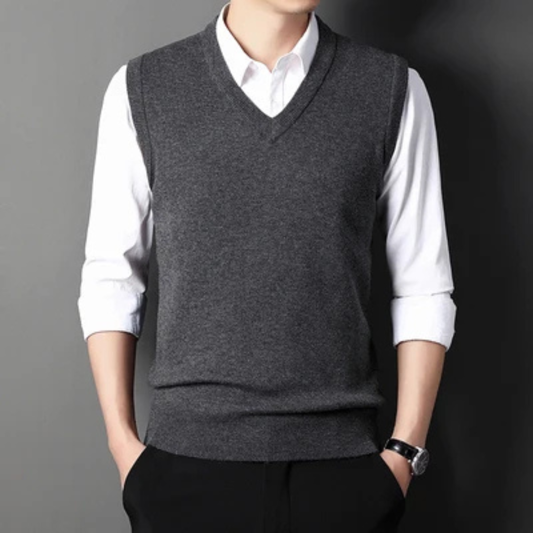 Men's sleeveless V-neck sweater vest layered over a collared shirt